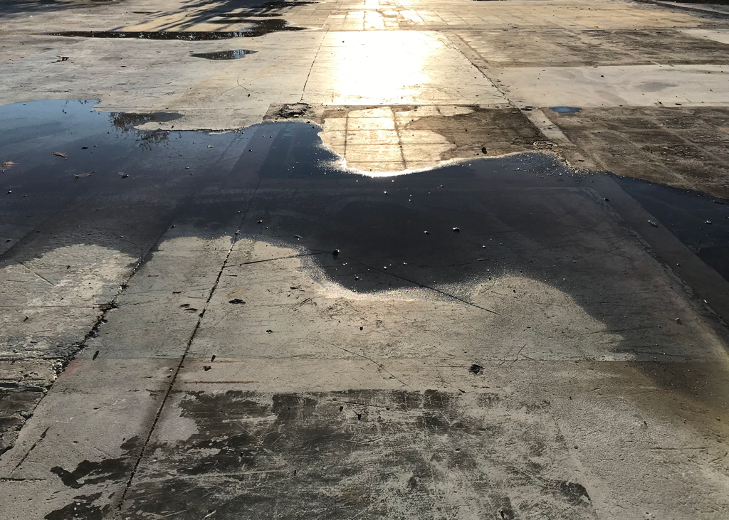 Dalle de l'ancien centre administratif de Nouvelle-Beauce, après que le bâtiment fut démoli pour cause d'inondation. Prise après un orage, la photo montre des accumulations d'eau faisant penser à la rivière Chaudière, située à quelques mètres de là.
